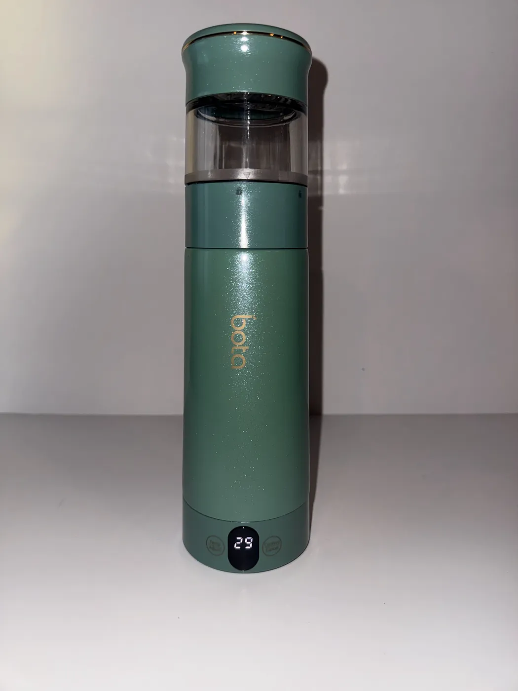 The lit display and touch panel at the base of the bottle